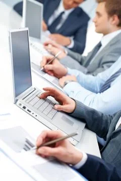 Close-up of female hand typing on computer keyboard in working environment Stock Photos