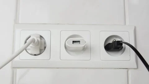 Close-up of a female hand unplugging one USB cable and connecting another cable. 스톡 동영상 339006831