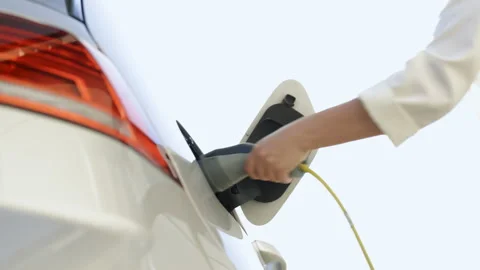 Close up of female hand unplugging power cable to environmentally friendly zero Video stock 200845511