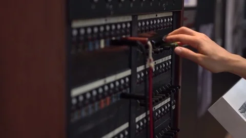 Close-up of female hand using 30-line teleprinter switchboard. Stock Footage 77712136