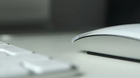 Close-up female hand using computer mouse on white desktop with selective foc Stock Footage 129561461