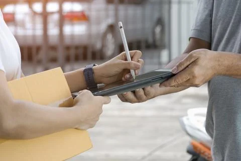 Close up female hand using electronic pen to signing signature on tablet af.. Stock Photos