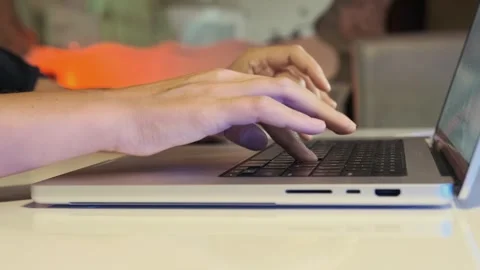 Close-up of female hand using laptop touchpad and keyboard, casual home Stock Footage 333725397
