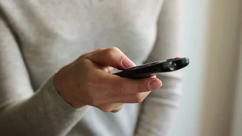 Close up female hand using television remote control Видео 150236165