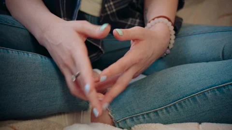 Close-up of female hands that actively gesticulate. Girl sitting in blue jeans Stock Footage 247576294