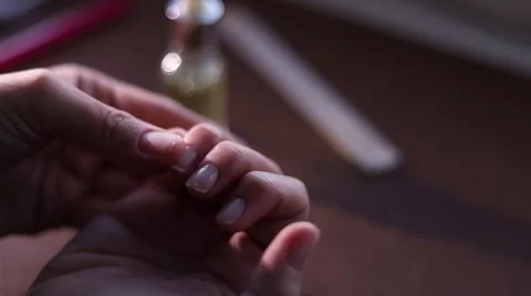 Close-up of female hands applying cuticle oil, rubbing them together in war.. Stock Footage 333845550