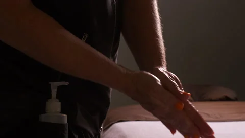 Close up of female hands applying massage oil. Stock Footage 259756401