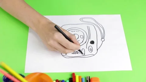 Close-up of female hands are drawing a camera. Stock Footage 166602742