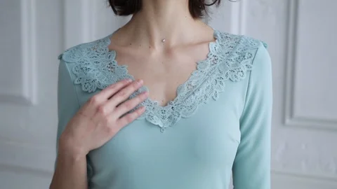 Close-up female hands are touching a lace collar of a dress.  Video stock 102049989