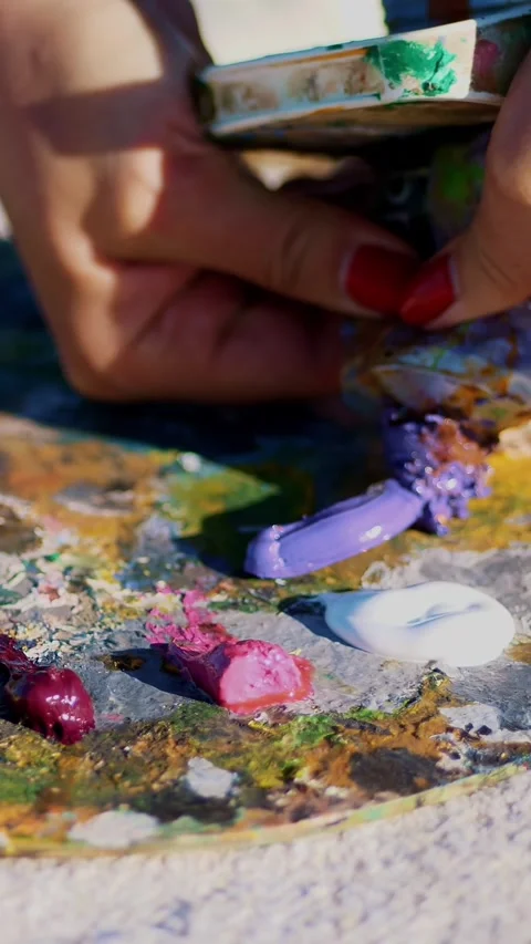 Close-up, female hands with bright red manicure. Art palette. The artist Stock Footage 317166935