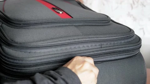 Close-up female hands close the suitcase and fasten it with a lock. The girl Video stock 210118399