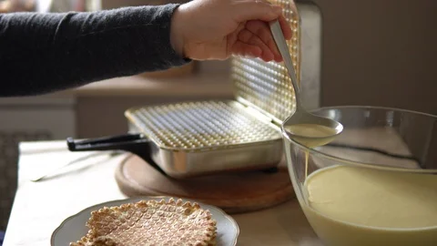 Close up on female hands cooking homemade waffles on vintage waffle-iron Stock Footage 124756053