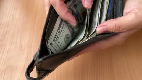 Close-up female hands counting and pulling out American 100 dollar bills Stock Footage 220732266