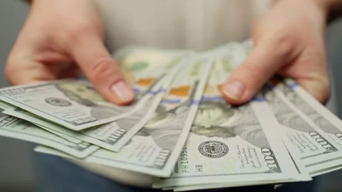 Close-up of female hands counting dollar bills in hands. Stock Footage 263027529