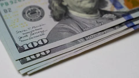 Close-up of female hands counting a stack of hundred dollar Stock Footage 256215920