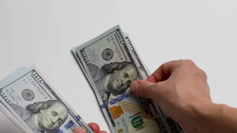 Close-up of female hands counting a stack of hundred dollar Stock Footage 256216023