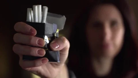 Close up female hands crushing a pack of cigarettes Stock Footage 69944934