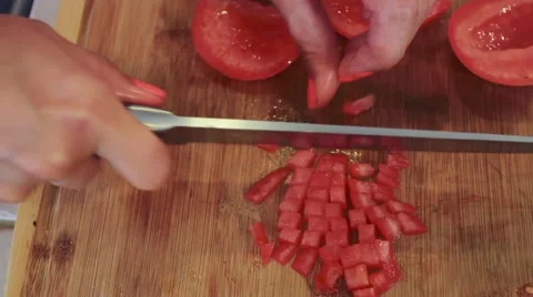 Close-up of female hands cutting and slicing a tomato Stock Footage 45274934