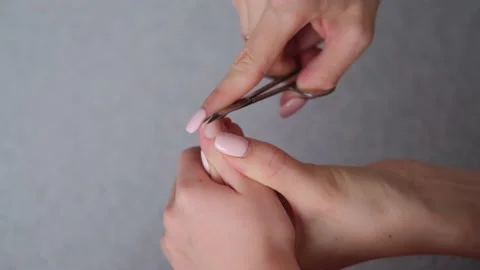 Close-up of female hands cutting the nails of a child. Hygiene. Stock Footage 149595760