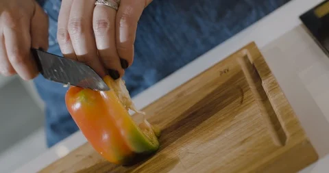 Close up of female hands cutting yellow pepper. Мoving shot. Stock Footage 124003339