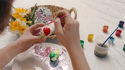 Close up of female hands decorating eggs for Easter with red heart shape Stock Footage 219787449