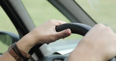 Close-up of female hands of the driver on the steering wheel. Stock Footage 97365562