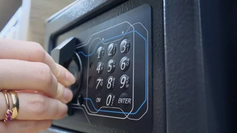 Close-up of female hands entering code on safe. Stock Footage 304987595