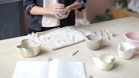 Close-up, female hands form a pot from a clay ball Stock Footage 107313123