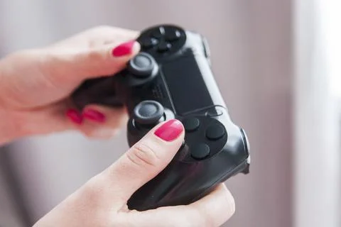 Close-up of female hands with gamepad while playing Stock Photos