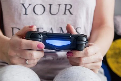 Close-up of female hands with gamepad while playing Stock Photos