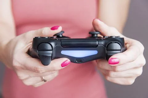 Close-up of female hands with gamepad while playing Stock Photos