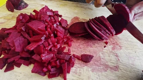 Close up of female hands in gloves cutting beet on kitchen board Stock Footage 304484565