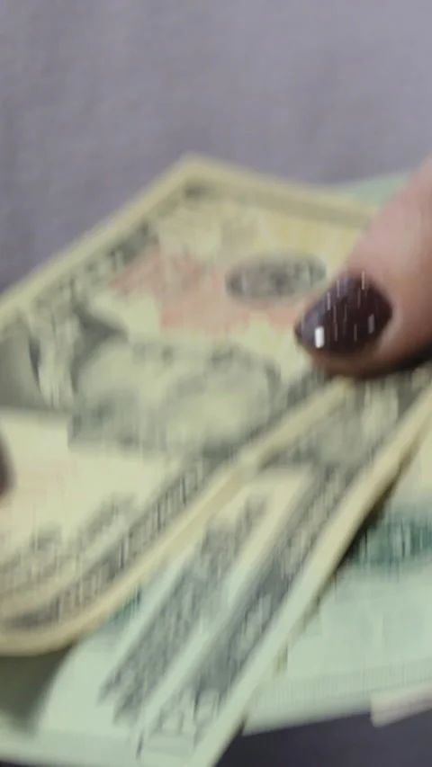 Close-up of female hands of hands counting US dollar bills. girl counts cash Stock Footage 229966603