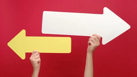 Close up of female hands hold two paper arrow pointing left and right Stock Footage 163513840