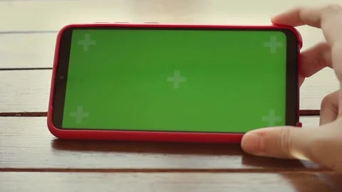 Close-up of female hands holding a cell phone has green screen display Stock Footage 201286268