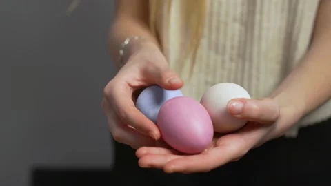 Close-up of female hands holding Easter eggs. Christ is risen. Church holiday Stock Footage 171490416