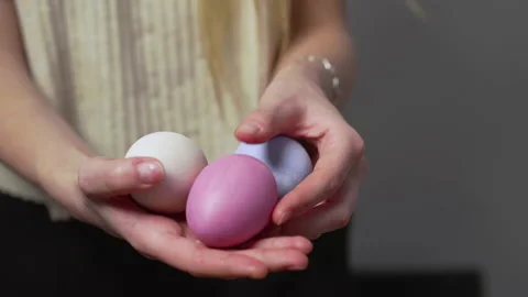 Close-up of female hands holding Easter eggs. Christ is risen. Church holiday Stock Footage 176413306