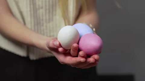 Close-up of female hands holding Easter eggs. Christ is risen. Church holiday Stock Footage 176414859
