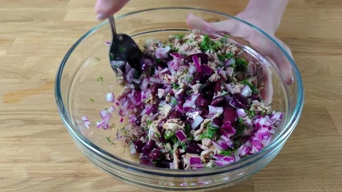 Close up female hands holding fork, mixing the salad in a large bowl. Stock Footage 155609640