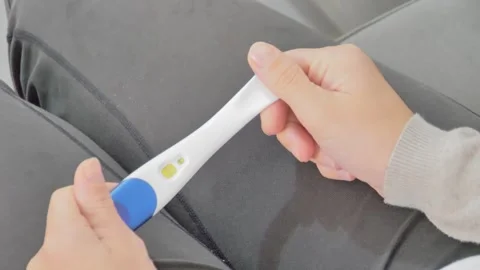 Close-up of female hands holding a pregnancy test Stock Footage 261457776