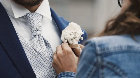 Close-up of female hands insert buttonhole. Stock Footage 93797548