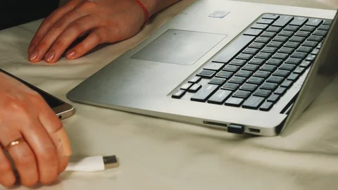 Close-up of female hands inserting the USB lamp into the laptop Stock Footage 108054485