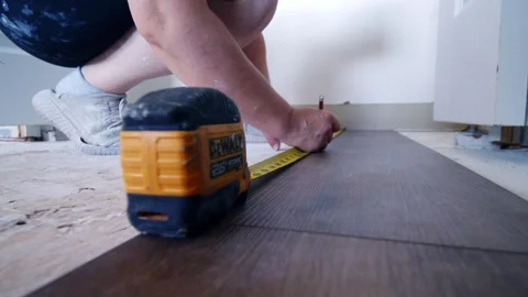 Close Up Female Hands Installing Interlocking Vinyl Flooring Living Room Floor Video stock 312525915