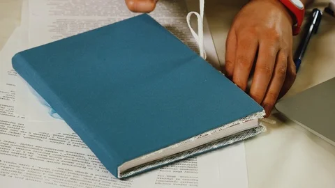 Close-up of female hands that leaf through the pages in a handmade notebook Stock Footage 108056108
