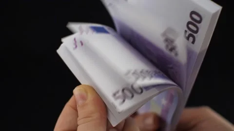 Close-up. Female hands leaf through a stack of euro bills in slow motion on a Stock Footage 232887850