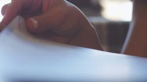 Close up of female hands is looking the menu at the restaurant on blurred bokeh Stock Footage 79874747