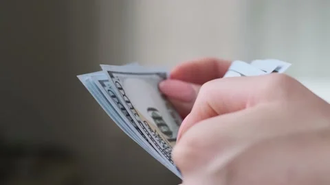 Close up of female hands manually counting the number of US dollars. Stock Footage 157149172