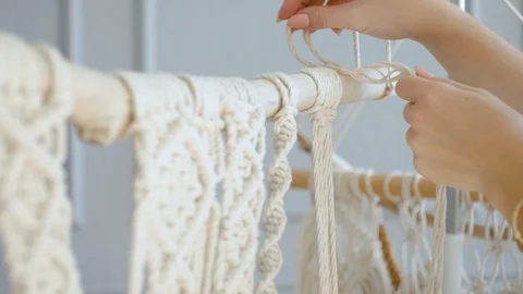 Close-up female hands of a master throws a rope on macram Stock Footage 120980639