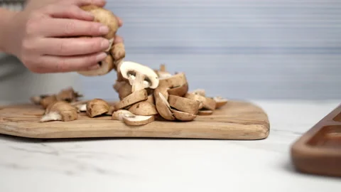 Close-up of female hands moving chopped mushrooms. Stock Footage 134685261