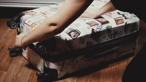 Close-up of female hands opening a suitcase Stock Footage 101646925